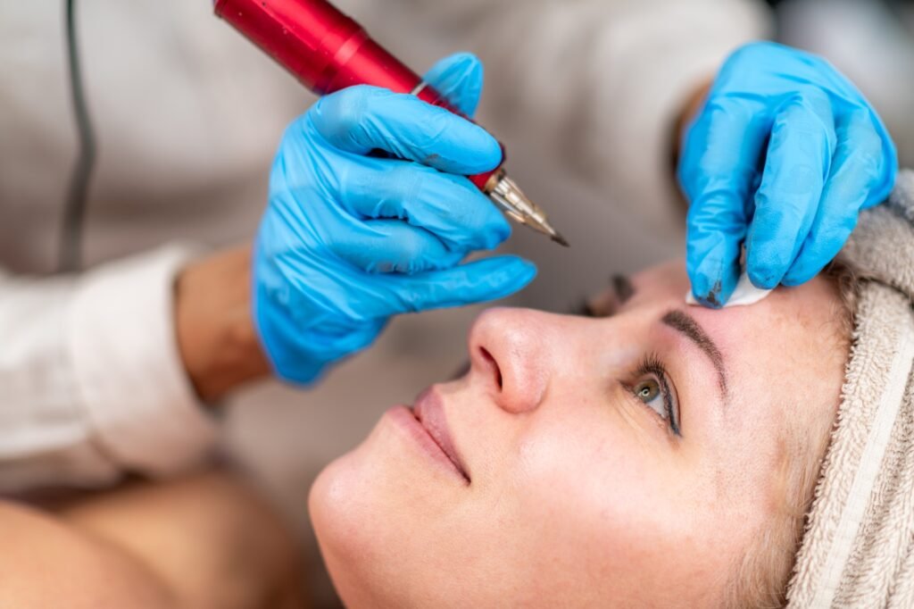 Eyebrow tattooing or microblading in a professional eyebrow salon.
